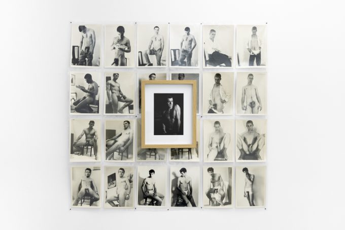 An installation photograph of black and white photography in a white-walled gallery space.