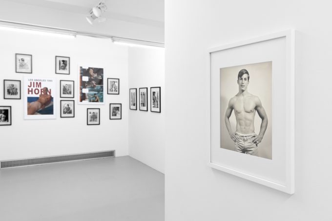 An installation photograph of black and white photography in a white-walled gallery space.