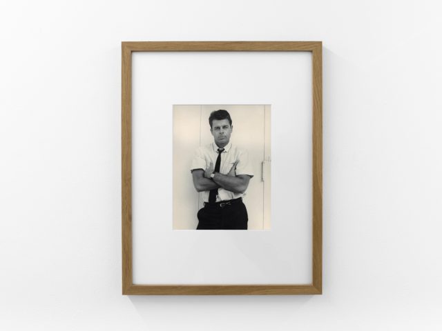 An installation photograph of black and white photography in a white-walled gallery space.