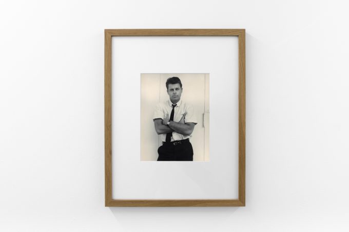 An installation photograph of black and white photography in a white-walled gallery space.