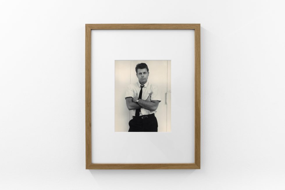 An installation photograph of black and white photography in a white-walled gallery space.