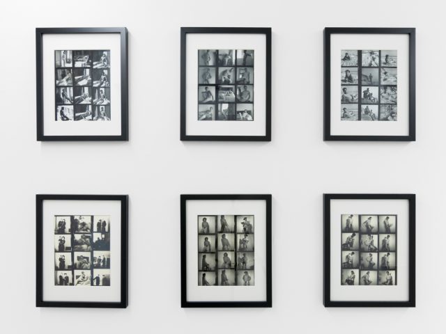 An installation photograph of black and white photography in a white-walled gallery space.