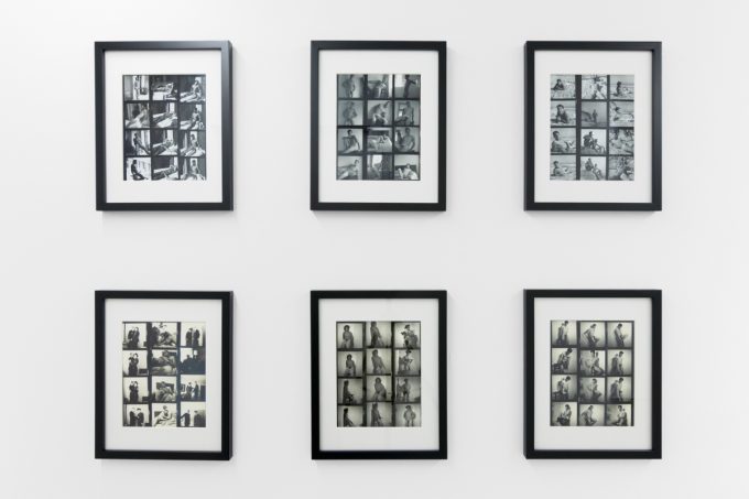 An installation photograph of black and white photography in a white-walled gallery space.