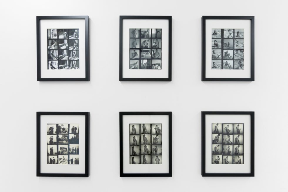 An installation photograph of black and white photography in a white-walled gallery space.