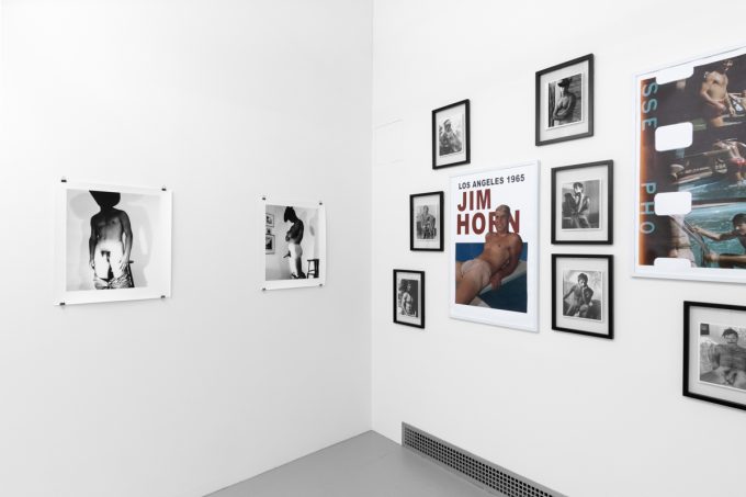 An installation photograph of black and white photography in a white-walled gallery space.