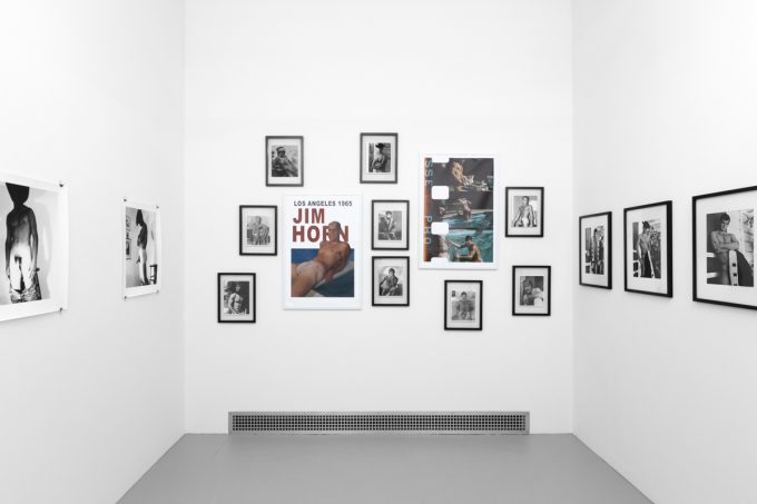 An installation photograph of black and white photography in a white-walled gallery space.