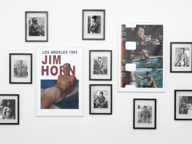 An installation photograph of black and white photography in a white-walled gallery space.