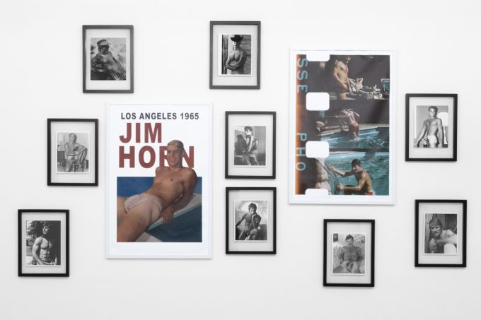 An installation photograph of black and white photography in a white-walled gallery space.