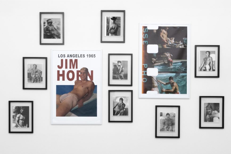 An installation photograph of black and white photography in a white-walled gallery space.