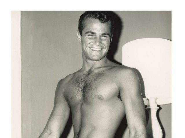 A black and white photograph of a nude model.