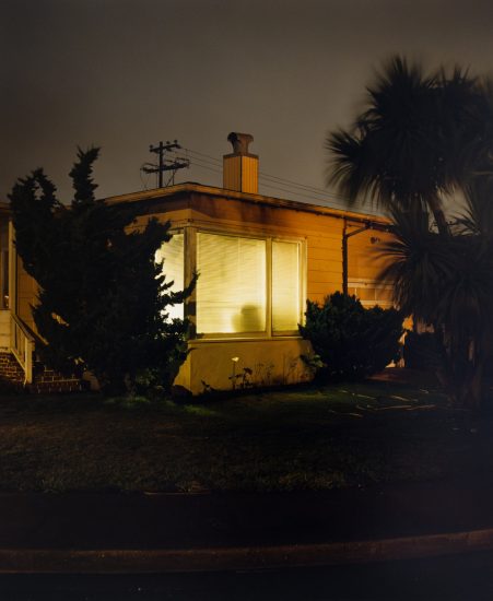A photograph of a house at night.