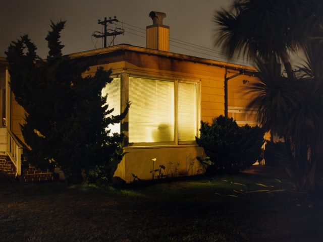 A photograph of a house at night.