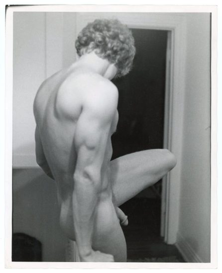 A black and white photograph of a nude man.