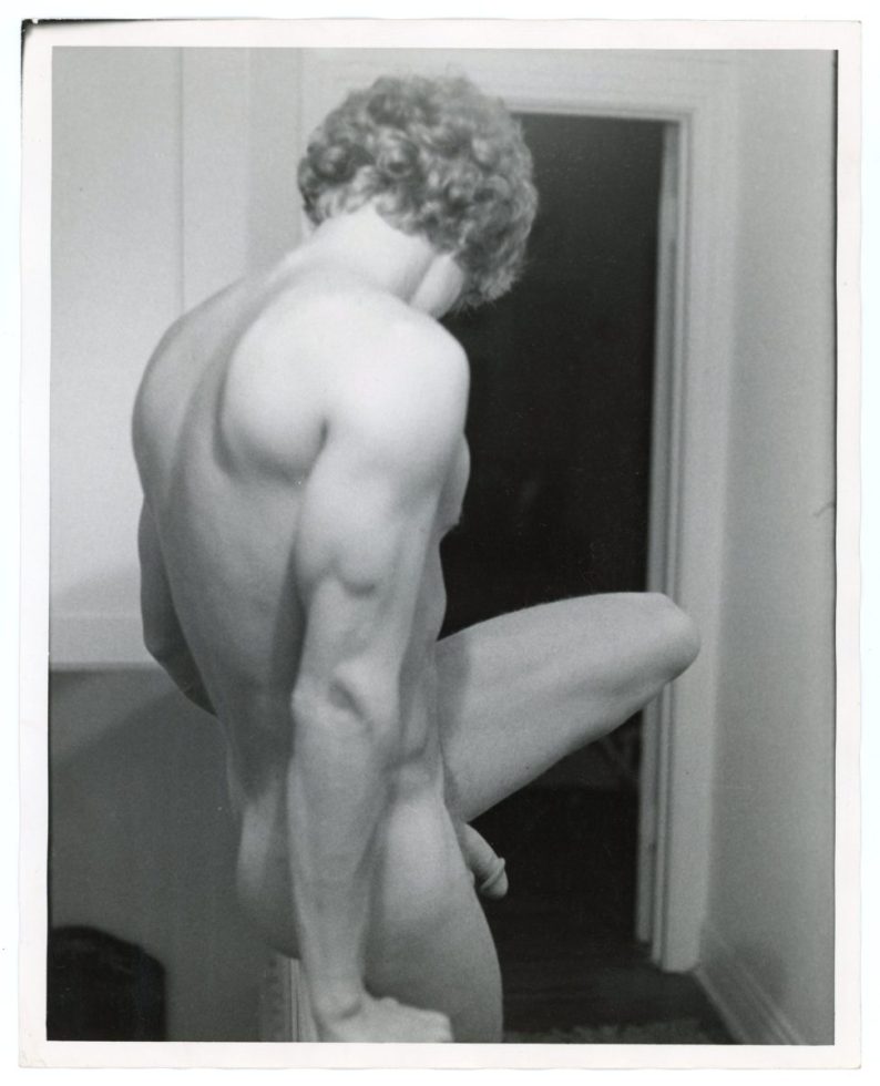 A black and white photograph of a nude man.