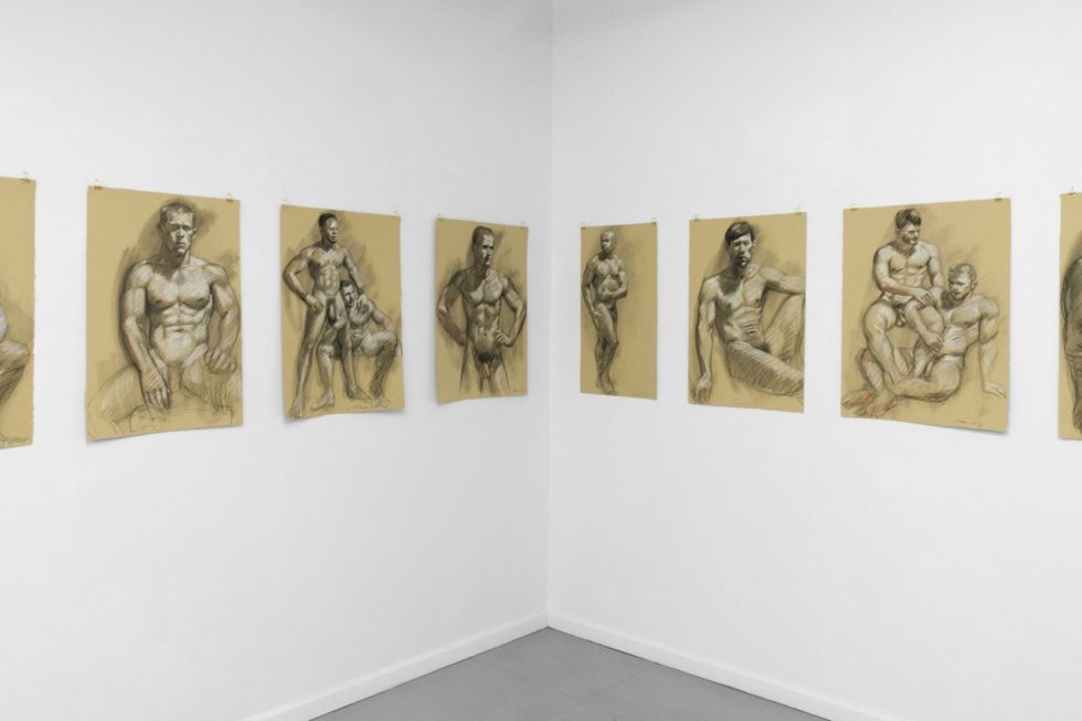 An installation photograph of various figurative artworks on a white gallery wall.