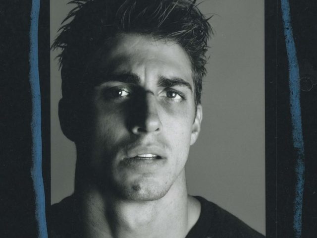 A black and white portrait of a handsome man.