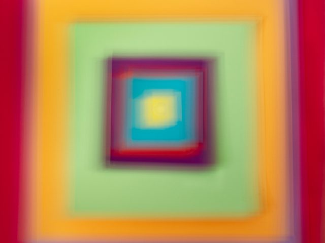 A colorful soft-focus image of various squares in many colors and hues.