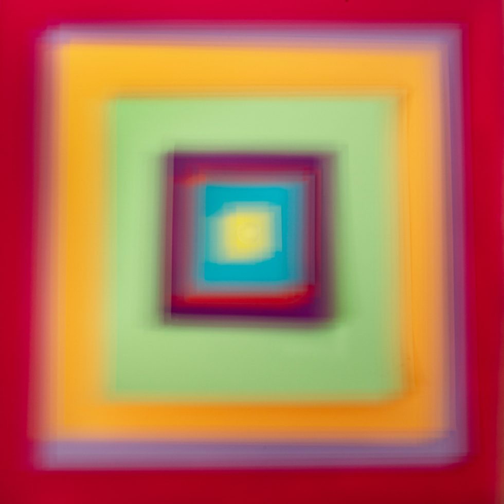 A colorful soft-focus image of various squares in many colors and hues.