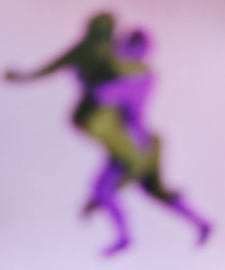 A purple-hued soft focus image of a couple embracing.