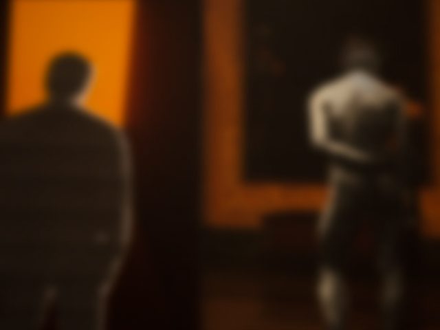 An orange-hued image of two figures.