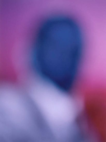 A colorful soft focus image of a figure rendered in purple and blue hues.