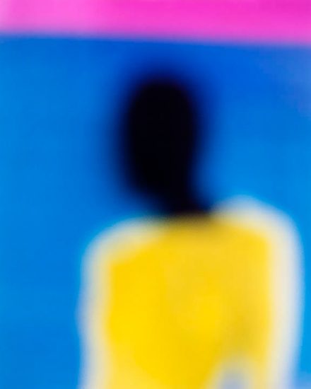 An abstract, soft focus image with yellow, blue, black, and pink.