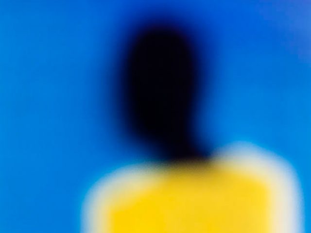 An abstract, soft focus image with yellow, blue, black, and pink.