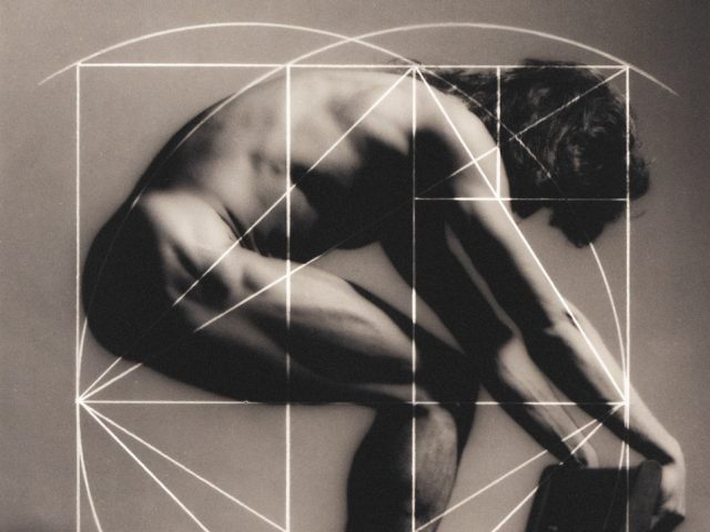 A black and white photograph of a man hunched over with lines overlayed.