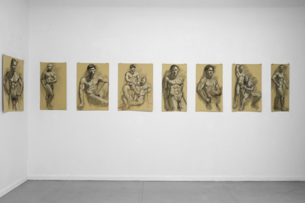 An installation photograph of various figurative artworks on a white gallery wall.