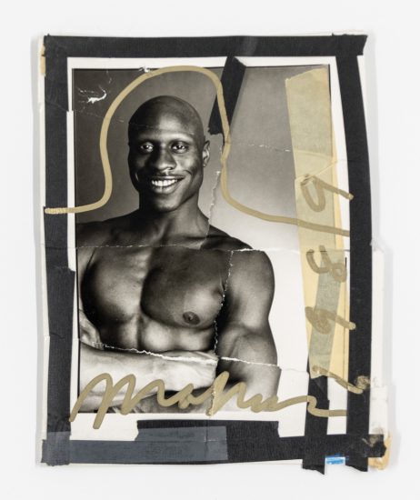 A black and white collage of a smiling shirtless man.