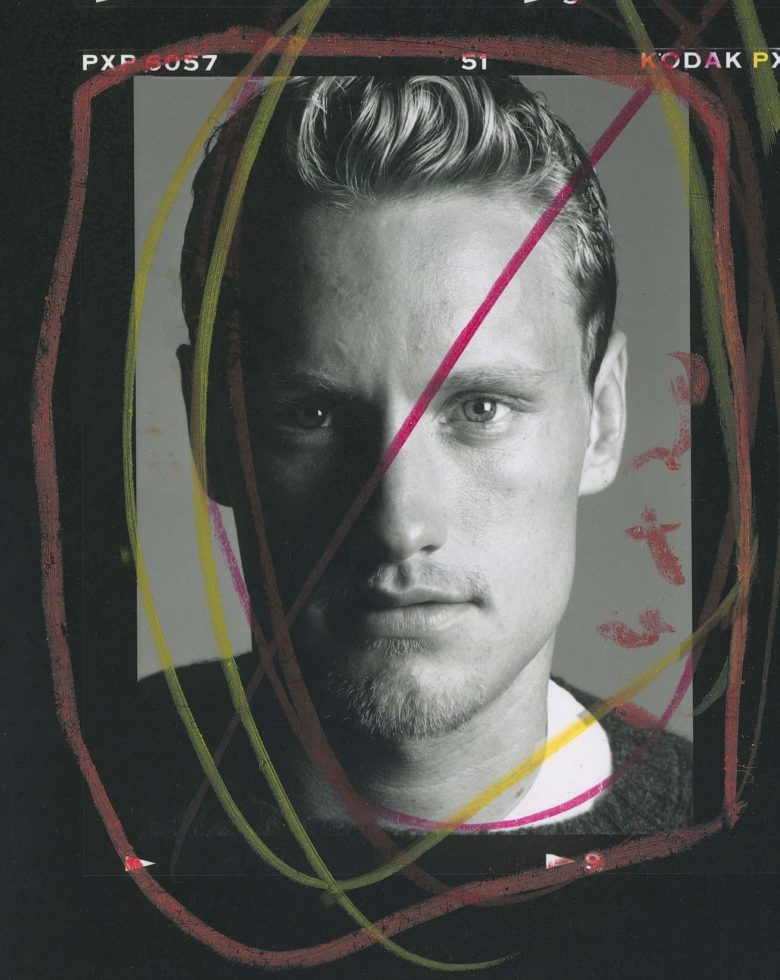 A black and white photograph of a man staring at the camera.