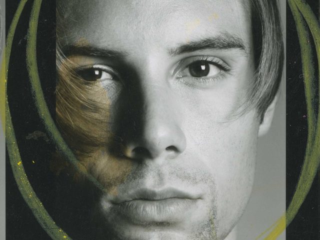 A black and white portrait of a handsome young man.