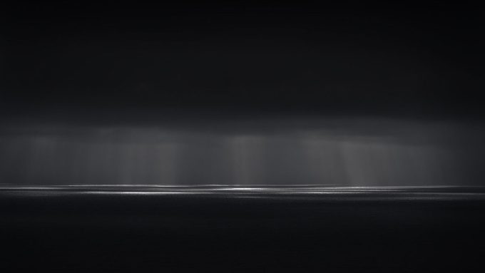 A photograph of a body of water with reflected light on the surface and a horizon line.