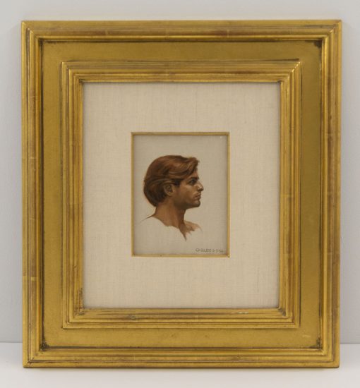 A small painting of a man in profile in a gilded frame.