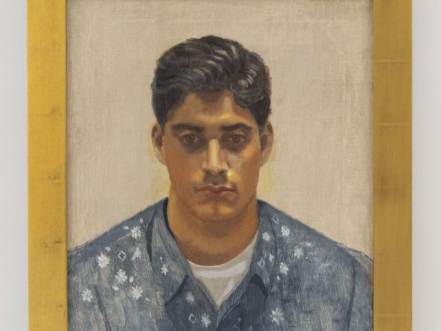 A painting of a man in a blue shirt in a gilded frame.