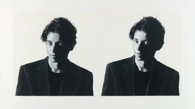 A black and white portrait of two men on a white background.