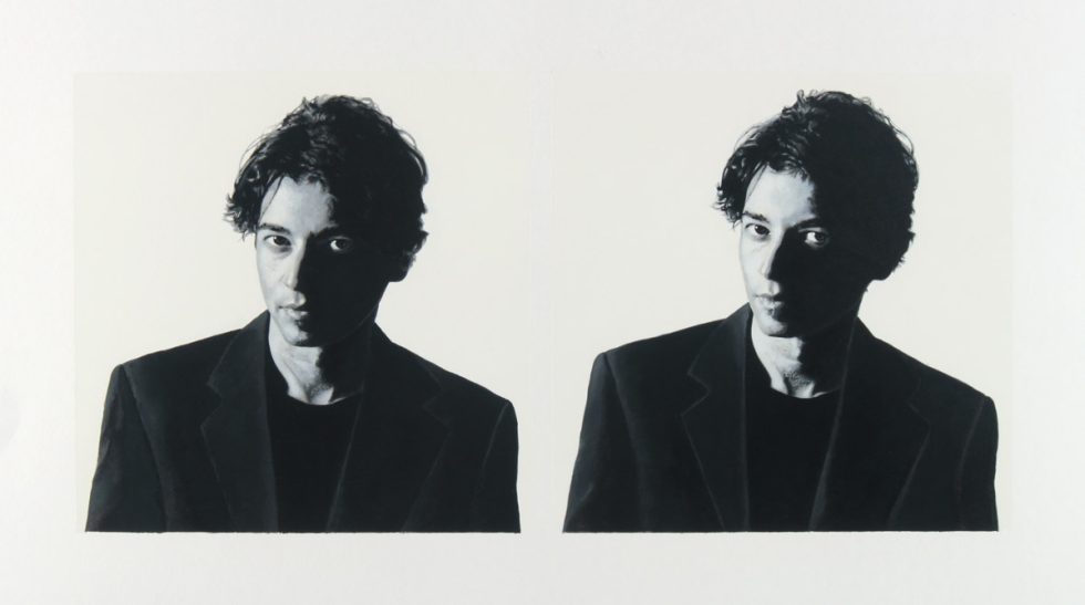 A black and white portrait of two men on a white background.