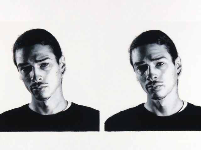 A black and white portrait of two men on a white background.