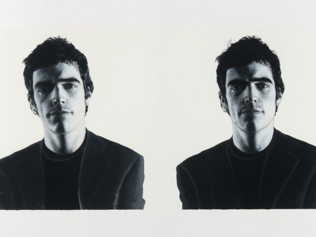 A black and white portrait of two men on a white background.