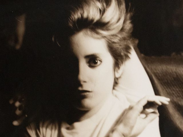 A sepia tone portrait of a young boy.