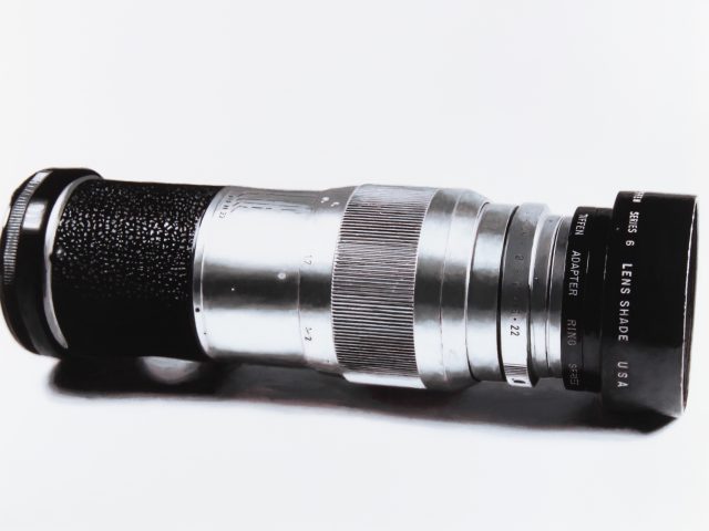 A black and white drawing of a camera lens on a white still life backdrop.