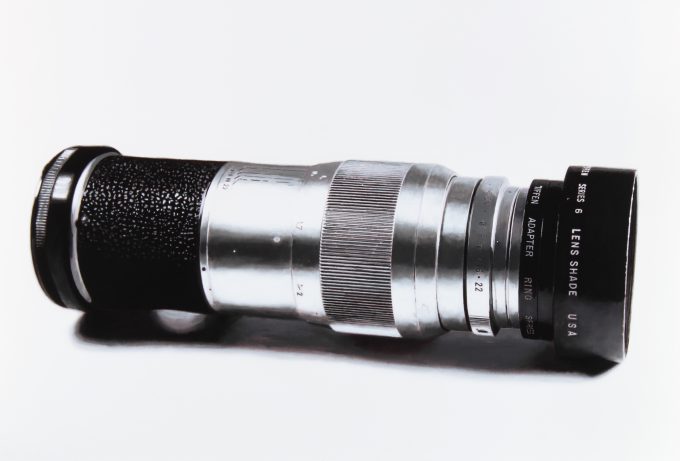 A black and white drawing of a camera lens on a white still life backdrop.