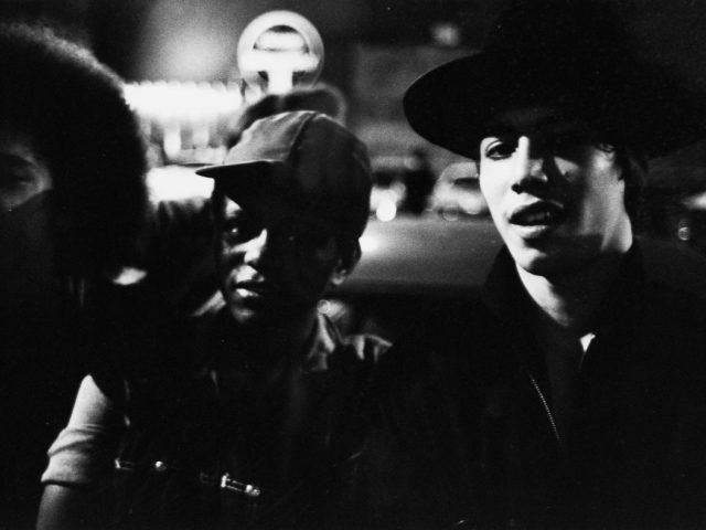 A black and white photograph of young men hanging out.