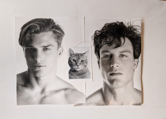 A black and white photograph of two handsome young men with a little kitty.