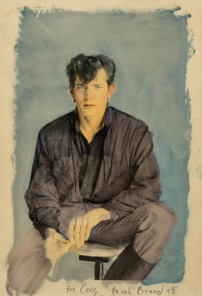 A hand-colored photograph of a man with yellow skin against a blue background.