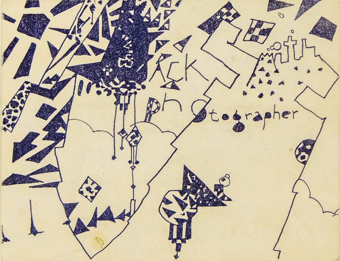 A business card with jagged, geometric, abstract shapes in dark blue.