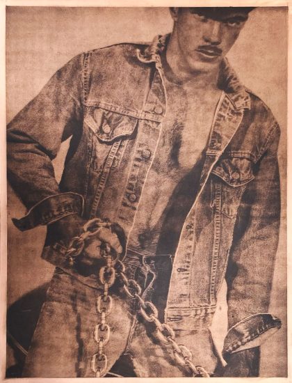 A copper image of a man in denim clothing holding a chain.