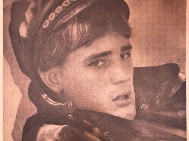 A copper print of a man in a leather jacket with cap.