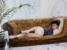 A painting of a nude boy on a sofa.