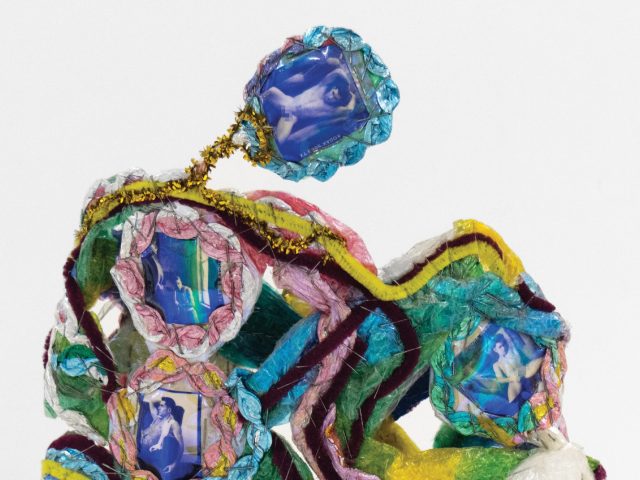 A colorful sculpture with pipe cleaners and photographs.
